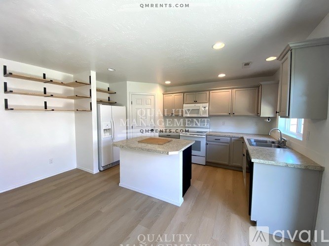 A kitchen with a white countertop and cabinets, and a dining area with a table and chairs.