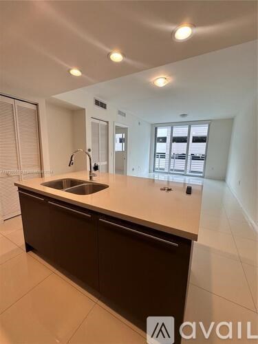 A modern kitchen with a sink and cabinets.