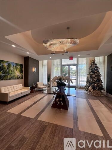 A living room with a Christmas tree and a white sofa.