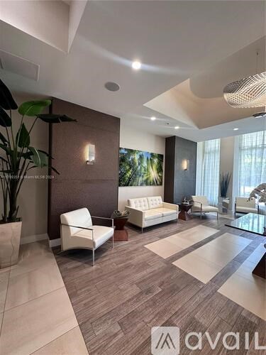 A living room with a white sofa and a glass table.
