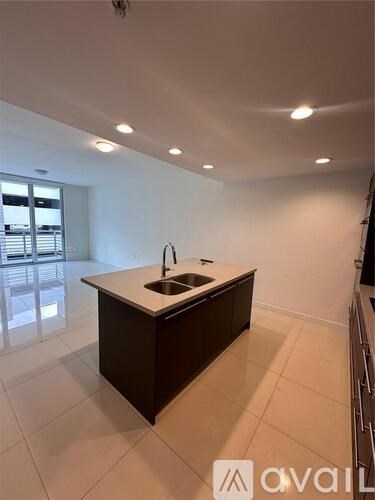 A kitchen with a sink and a countertop.