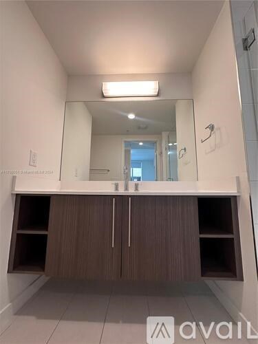 A large, empty room with a long counter and cabinets.