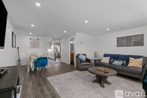 A living room with a grey couch and a coffee table.