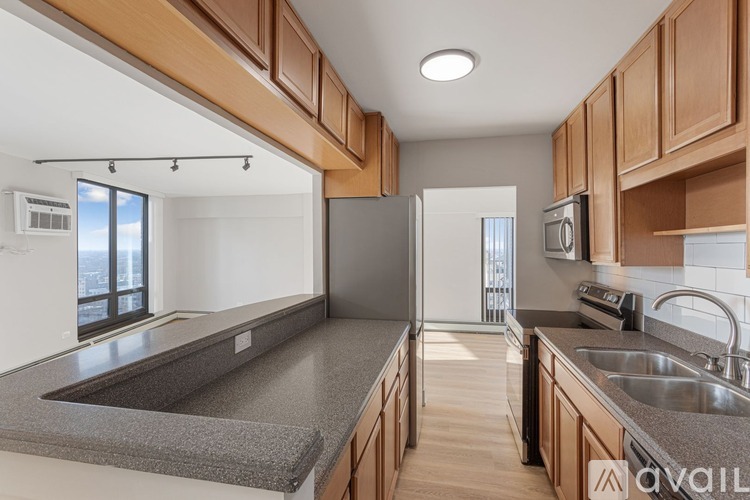 A kitchen with wooden cabinets and a grey countertop.