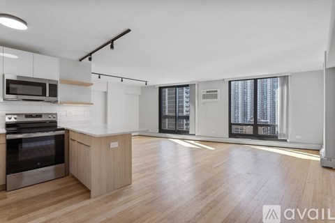 A kitchen with wooden floors and a stainless steel oven.