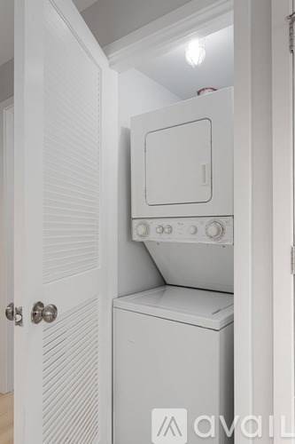 A white oven and microwave are installed in a kitchen.