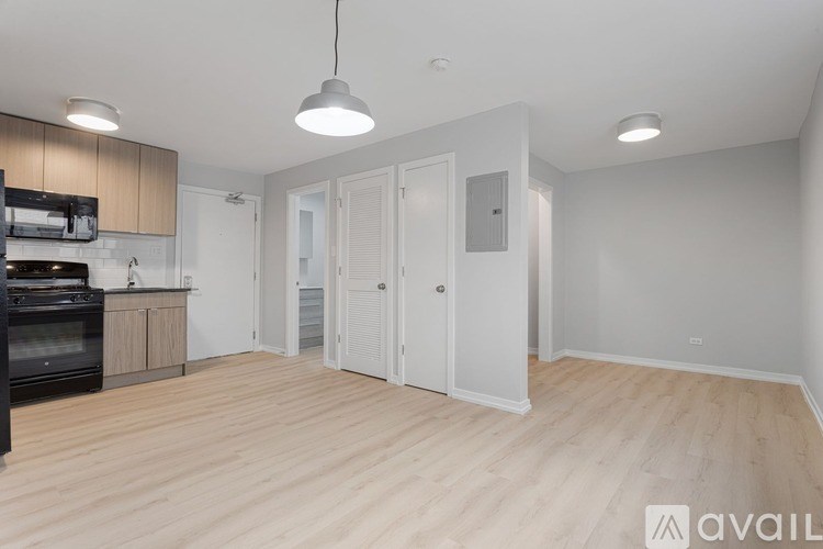 A kitchen with a black oven and wooden floors.