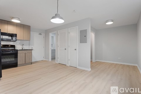 A kitchen with a black oven and wooden floors.