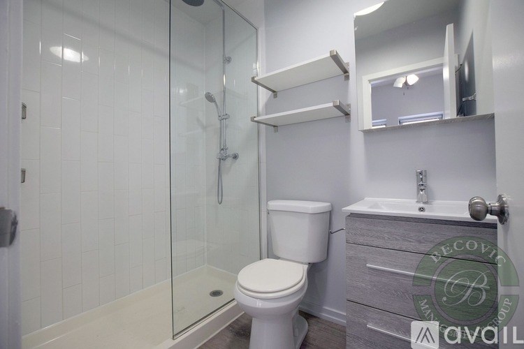 A white toilet in a bathroom with a glass shower door.