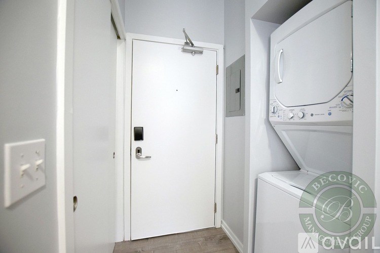 A white door with a handle and a small square hole in the middle of the door.