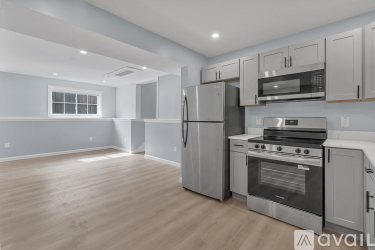 A kitchen with stainless steel appliances and wooden cabinets.