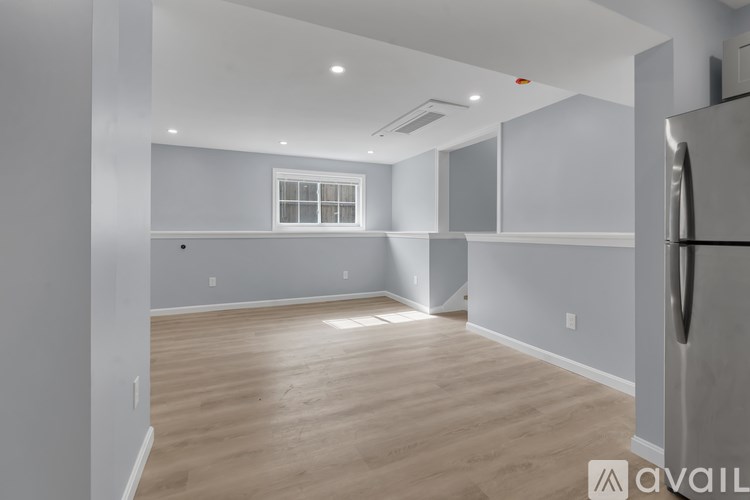 A kitchen with a refrigerator on the right side.