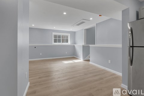 A kitchen with a refrigerator on the right side.