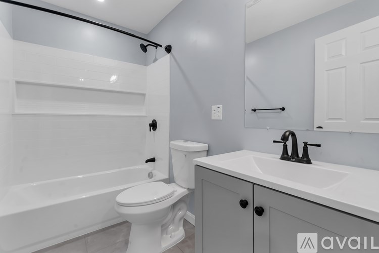 A bathroom with a white toilet and a white sink.