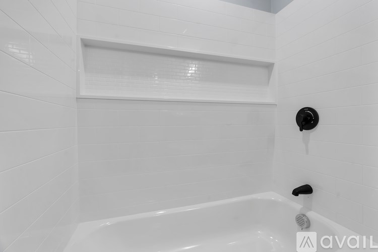 A white bathroom with a tub and a shower.