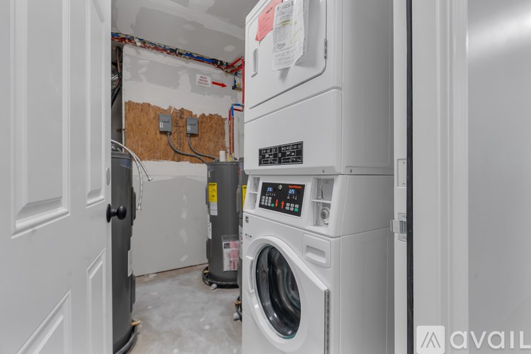 A washing machine is in a room under renovation.
