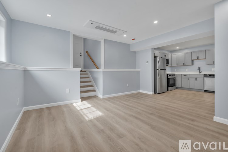 A spacious kitchen with a staircase leading to the upper floor.