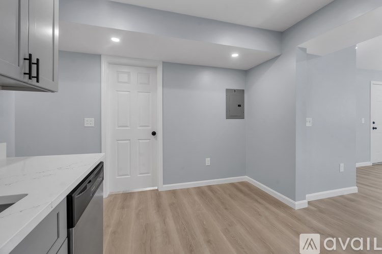 A kitchen with a white countertop and a white door.