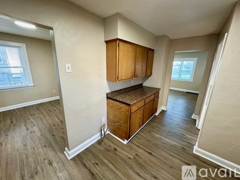A kitchen area with wooden cabinets and a countertop.