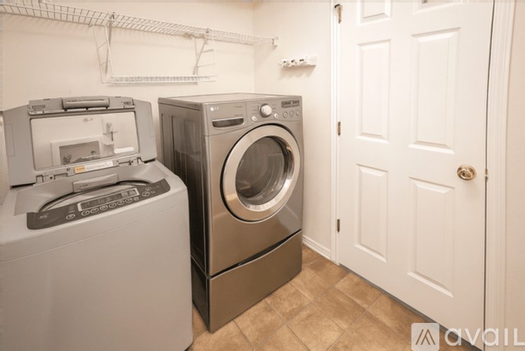 A washing machine and dryer in a small laundry room.