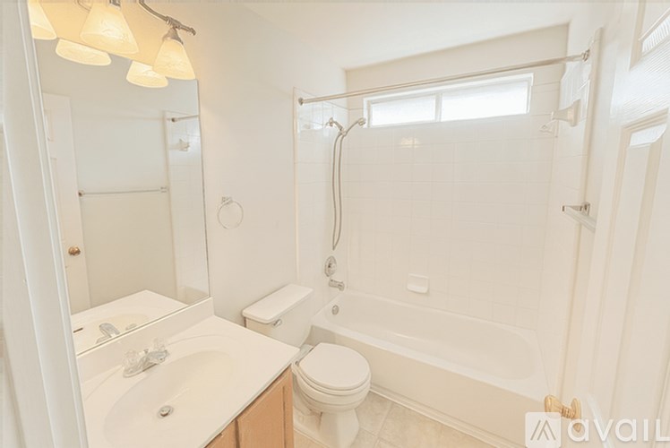 A white bathroom with a sink, toilet, and bathtub.