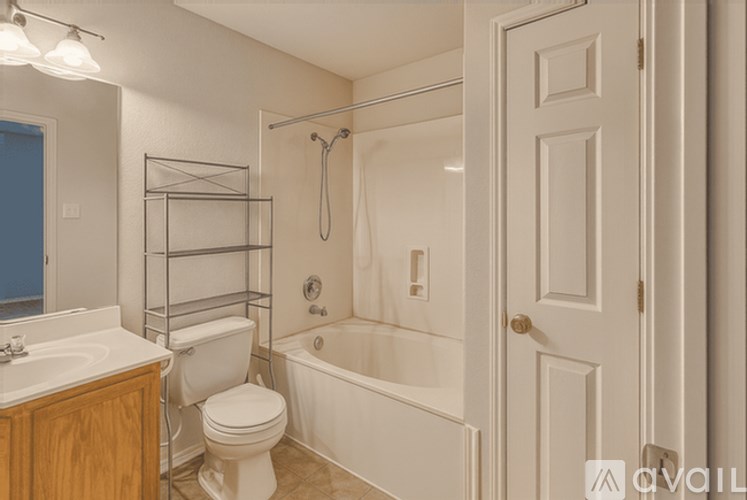 A white bathroom with a toilet, sink, and bathtub.