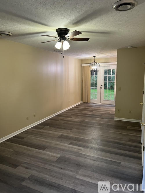 A room with a ceiling fan and light fixture.