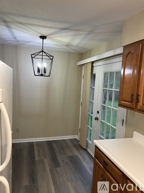 A kitchen with wooden cabinets and a white fridge.