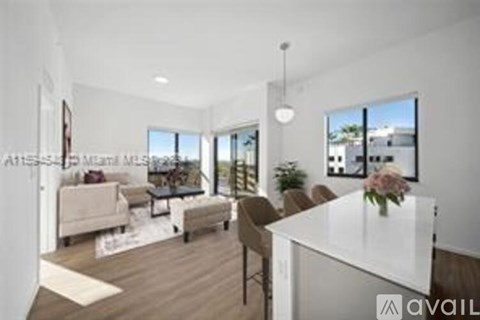 A modern living room with a white dining table and chairs.