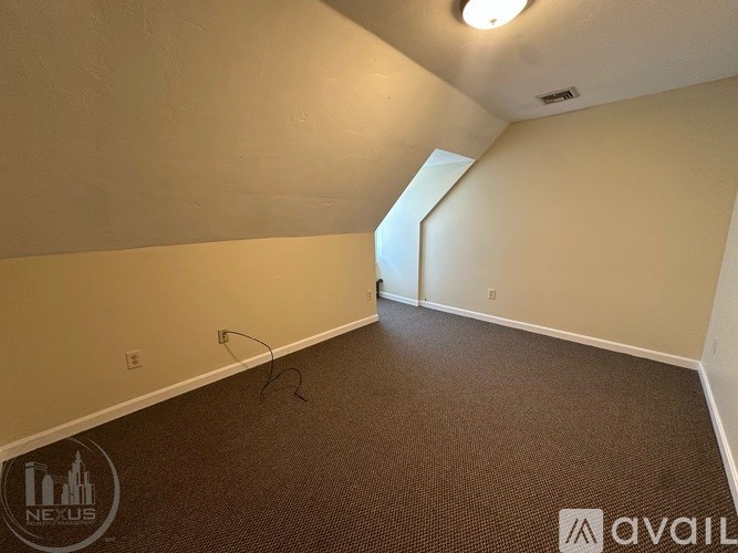 A room with a carpeted floor and a window.