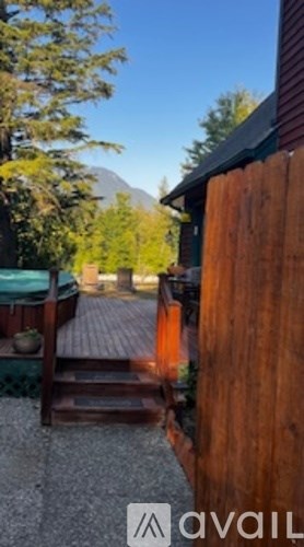 A wooden fence with a mountain in the background.