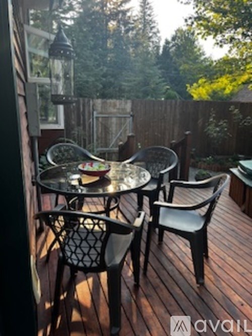 A patio with a round table and four chairs.