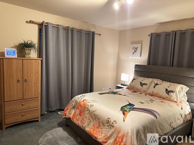 A bedroom with a bed, nightstand, and wardrobe.