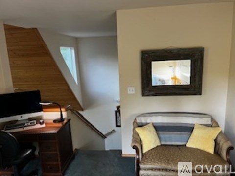 A living room with a couch and a chair.