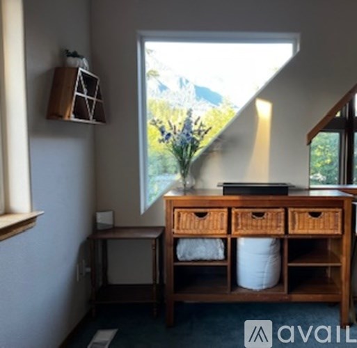 A room with a desk and a window.