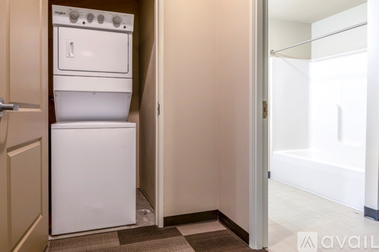 A white dishwasher and oven are in a small kitchen.