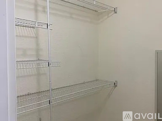 Empty shelves in a white refrigerator.