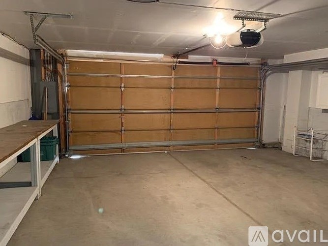 A garage with a brown door and a white ceiling.