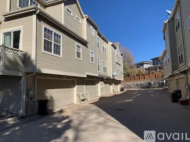 A sunny day at the outdoor parking lot of a residential building.