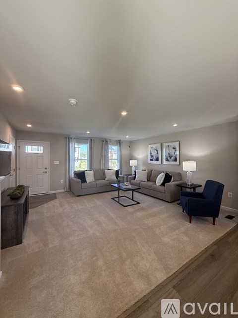 A living room with a couch, chair, and table.