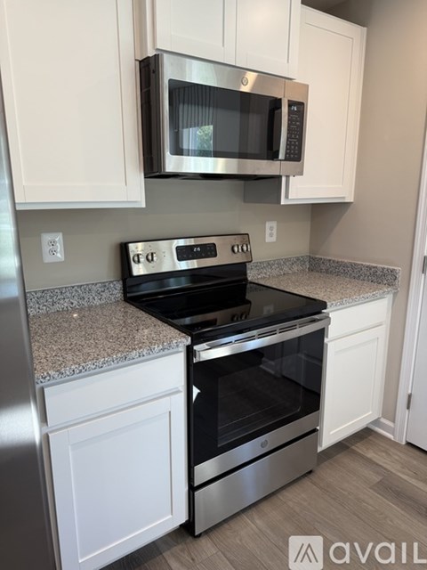 A kitchen with a stove top oven and microwave above it.