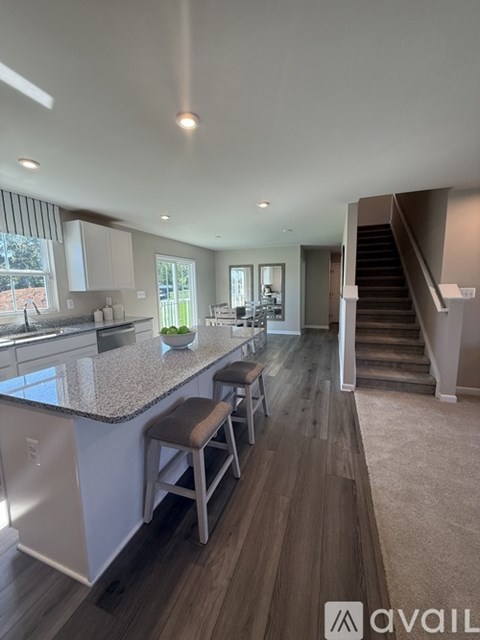 A modern kitchen with a bar stool and a countertop.