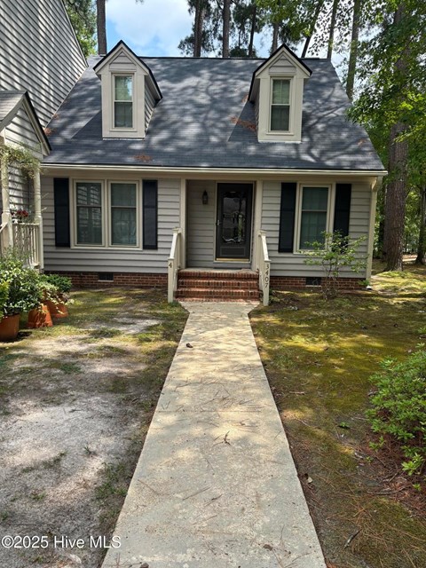 A house with a grey front and a white door.
