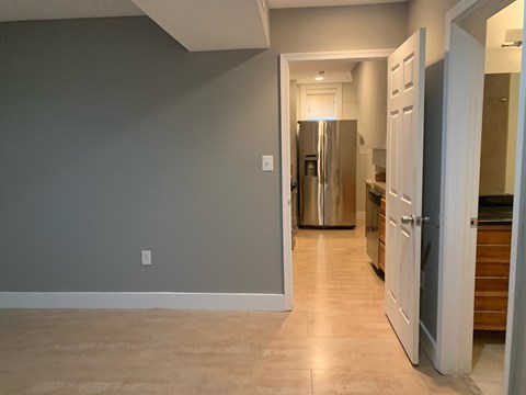 A kitchen with a refrigerator and a countertop.