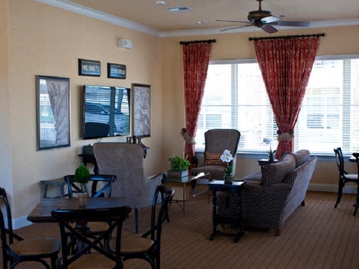 A living room with a dining table and chairs.
