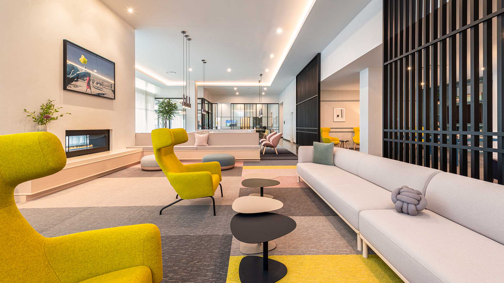A modern living room with a yellow chair and a white sofa.