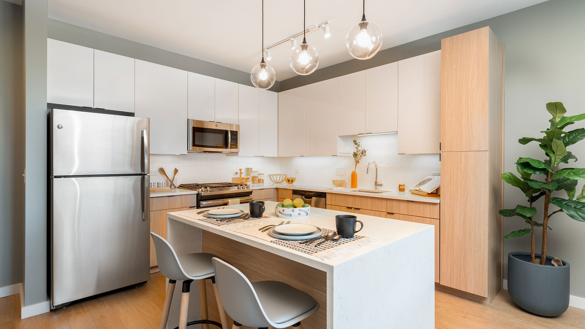 A modern kitchen with a dining table and chairs.