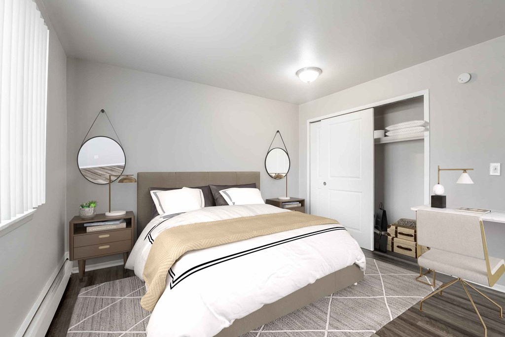 A bedroom with a large bed and a desk with a chair.