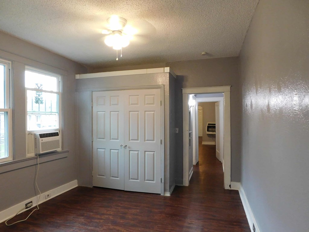 A room with a white door and a window.