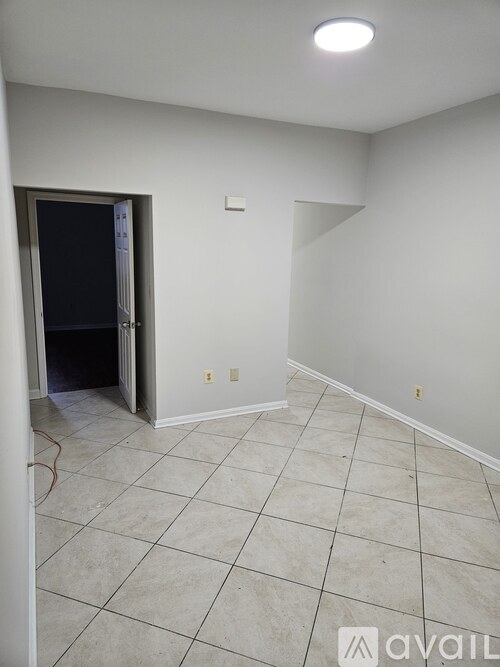 A room with a doorway leading to another room.